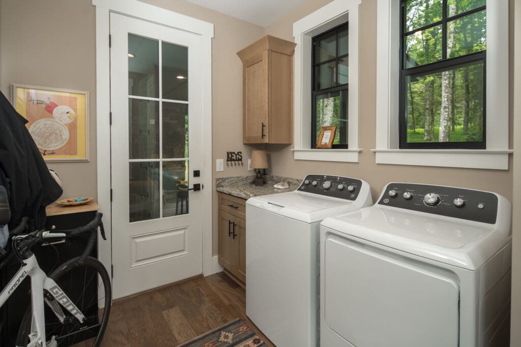 Laundry room with washer, dryer, and bicycle.