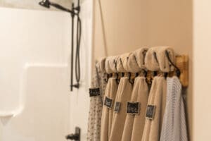 Towels hanging with name tags in bathroom.