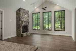 Spacious room with fireplace and large windows.