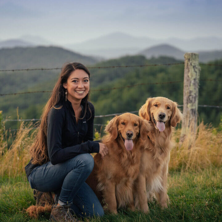 a woman with two dogs outside